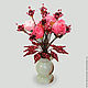 The flowers of pomegranate in a vase of onyx
