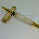 Pen Gift pen is made of pressed composite marble is white with light streaks of brown. Fittings made of jewelry of bronze and gold 750-th breakout
