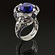 К004, белое золото 750 пробы.
Центральная вставка - танзанит 14.63ct.
Бриллианты - 1.136ct.
Бриллианты капли - 0.41ct.
Бриллианты сердце - 0.55ct.
Сапфиры - 1.658ct
Вес - 24.31 г.