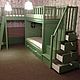 Bunk bed. Has two beds on the lower and upper layer, as well as two play areas at the top and bottom, connected by stairs. 
Provides storage system - 4 large drawers hidden under
