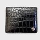 The cardholder is made of genuine crocodile leather, in black!