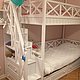 Graceful white bunk bed with spacious beds, ergonomic staircase, comfortable and practical storage system will be a truly favorite piece of furniture in the nursery.