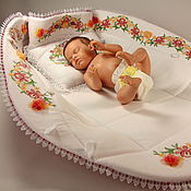 A cradle for a MAC doll