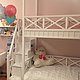 Graceful white bunk bed with spacious beds, ergonomic staircase, comfortable and practical storage system will be a truly favorite piece of furniture in the nursery.