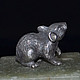 Miniature `Mouse`. There are statues of dogs: Dachshund, Bichon Frise, Airedale Terrier, poodle, Spaniel, Pekingese. There are figurines of other animals: elephant, turtle, cat, bear, rat, snake (Cobr