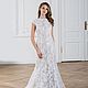 Wedding dress in mermaid style is made of two parts: basic dress in beige color and the upper gown of Chantilly lace embroidered with sequins.
