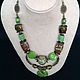 Necklace multi-row natural stones and ceramics in ethnic African style. Warm natural colors, herbal bright green, brown.