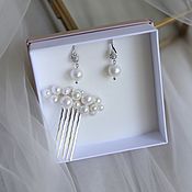 A set of jewelry for a wedding, a wedding twig in a hairstyle and earrings