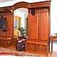 Entrance hall natural wood solid hardwood: oak, ash. Decorated in colonial style, has a wide mirror, soft elements, covered with leather. Storage system is presented