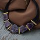 Necklace with cut amethyst. Necklace on leather cords. Necklace with amethyst.
