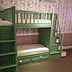 Bunk bed. Has two beds on the lower and upper layer, as well as two play areas at the top and bottom, connected by stairs. 
Provides storage system - 4 large drawers hidden under