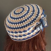 A hat with a boho-style olive decor