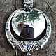 `Sagaan Toli` - `White mirror`, pendant-amulet from silver 925 with artificial diamond, cubic zirkonia and blue topaz, blackening. Weight 38,7 gr., The size 43х68 mm