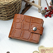 A small leather purse with an Owl pattern