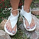 Sandals of white leather through the finger. handmade.
