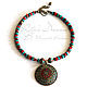 Short coral turquoise necklace with a large pendant and Tibetan beads inlaid with coral and turquoise. The necklace will make the image of a bright ethnic touch.
