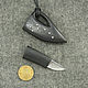 An unusual decoration pendant in the form of a miniature sharp knife made of real hardened steel